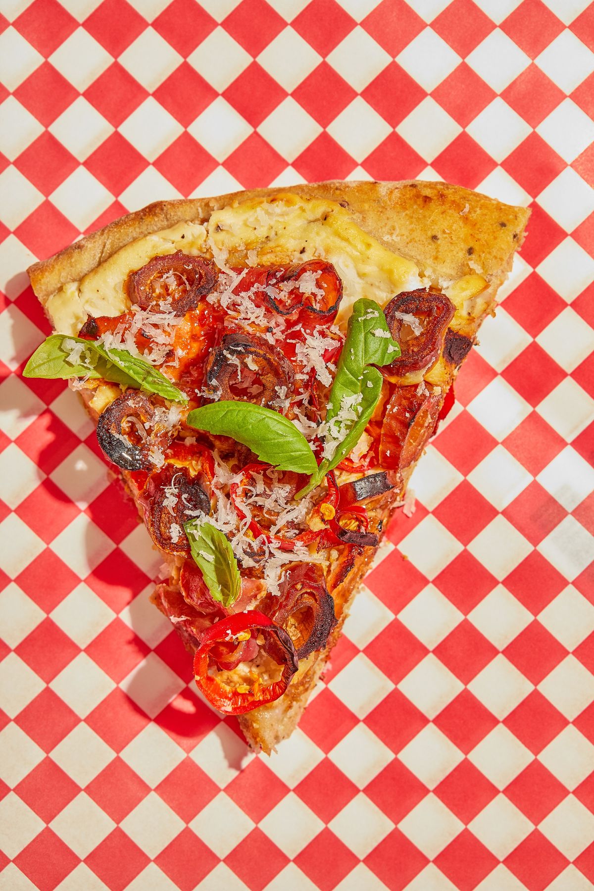 A slice of date pizza on a red gingham tablecloth