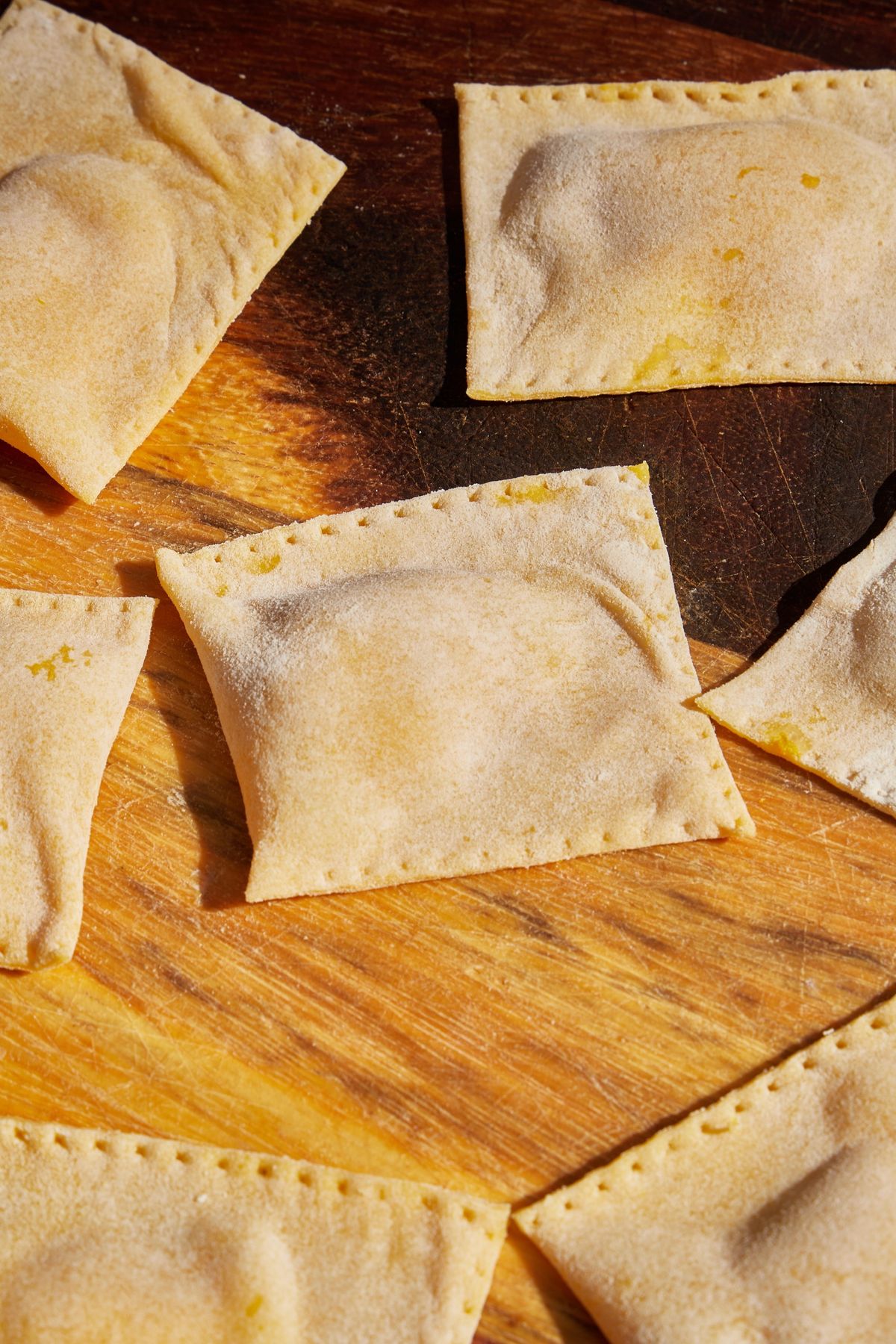 Handmade ravioli on a wooden board